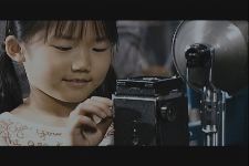 J, A Photographer in a Strange Village